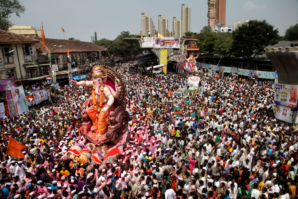 Lord Ganesha accompanied by thousands of devotees, in procession