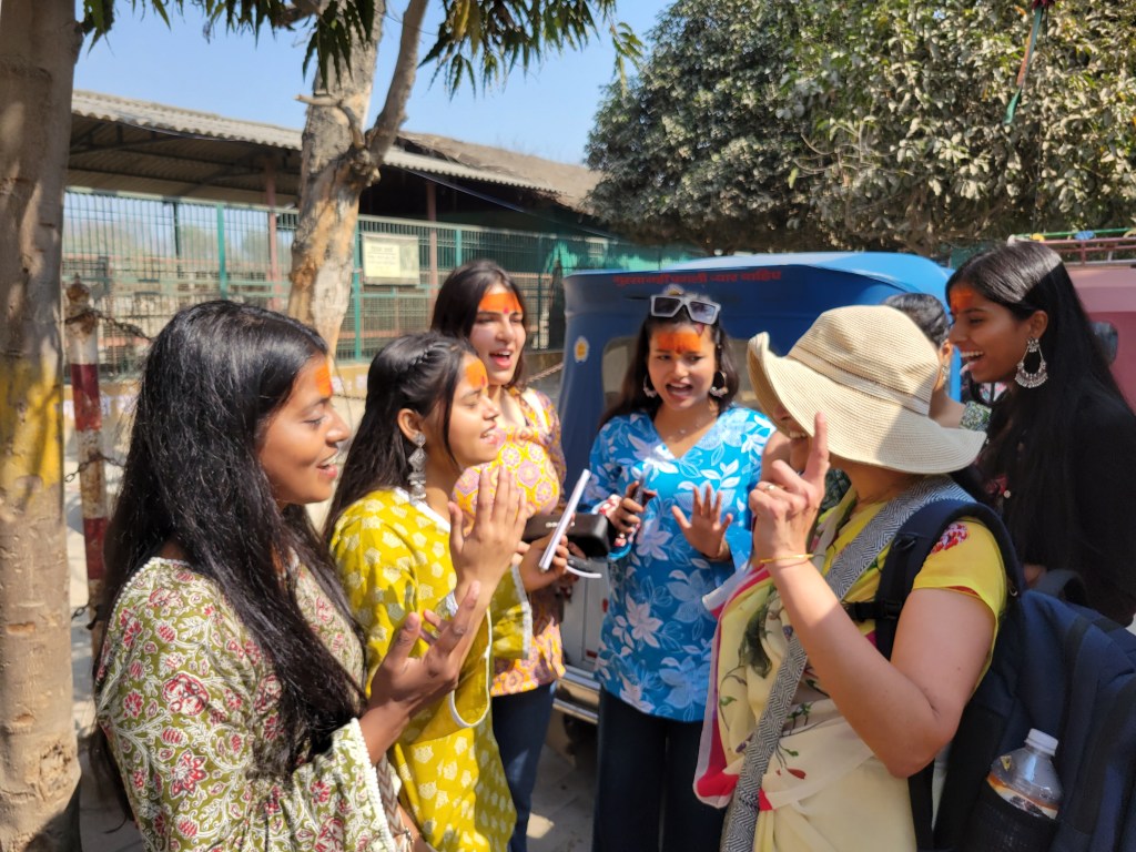 Enthusiastic Singing, Dancing, Chanting and Books, here Mother Malini distributes to a grpup of young girls...